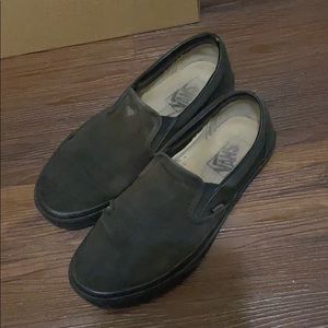 Extremely worn in black slip on vans